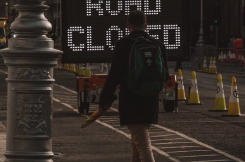 sign on tracks in black and white