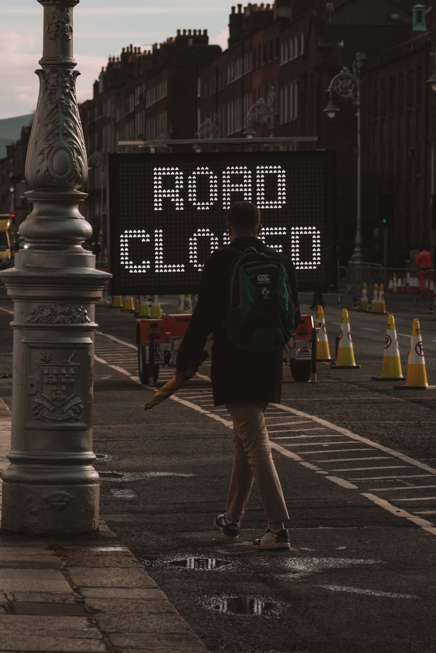 sign on tracks in black and white